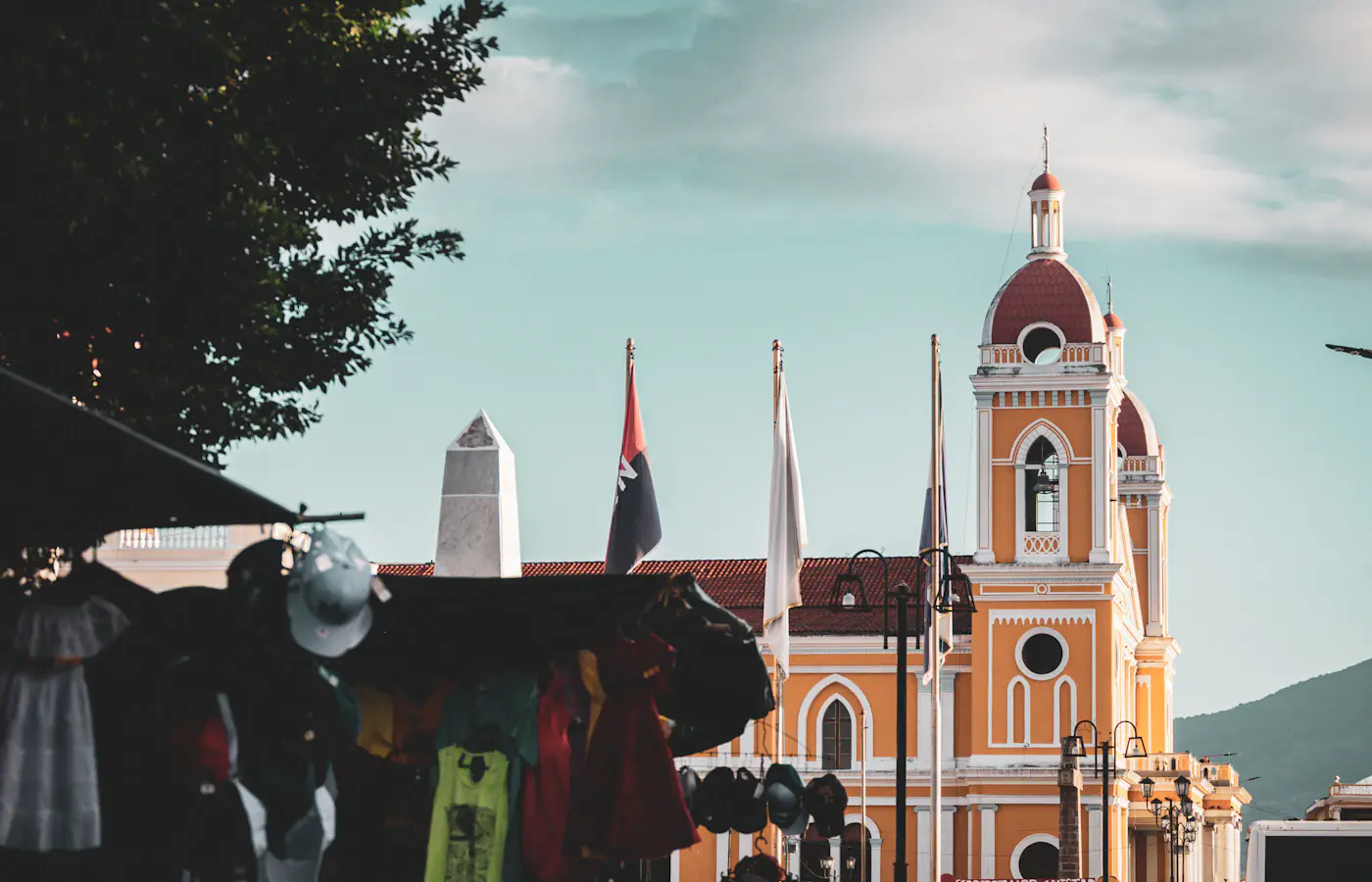 Granada cathedral with its yellow tower and market stalls in Nicaragua