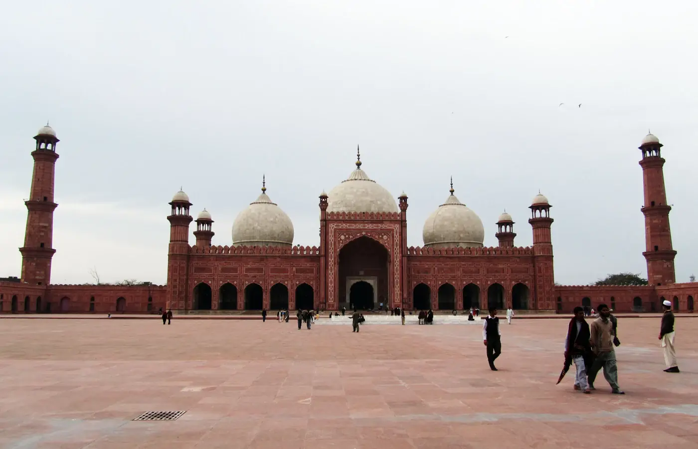 Three domes and minarets of Badshahi Mosque seen from its courtyard in Lahore, Pakistan