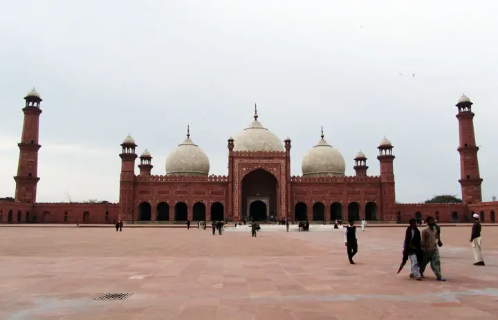 Three domes and minarets of Badshahi Mosque seen from its courtyard in Lahore, Pakistan